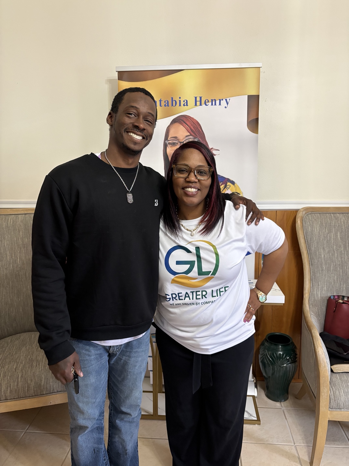 Apostle Katabia Henry welcoming a member of the Greater Life community